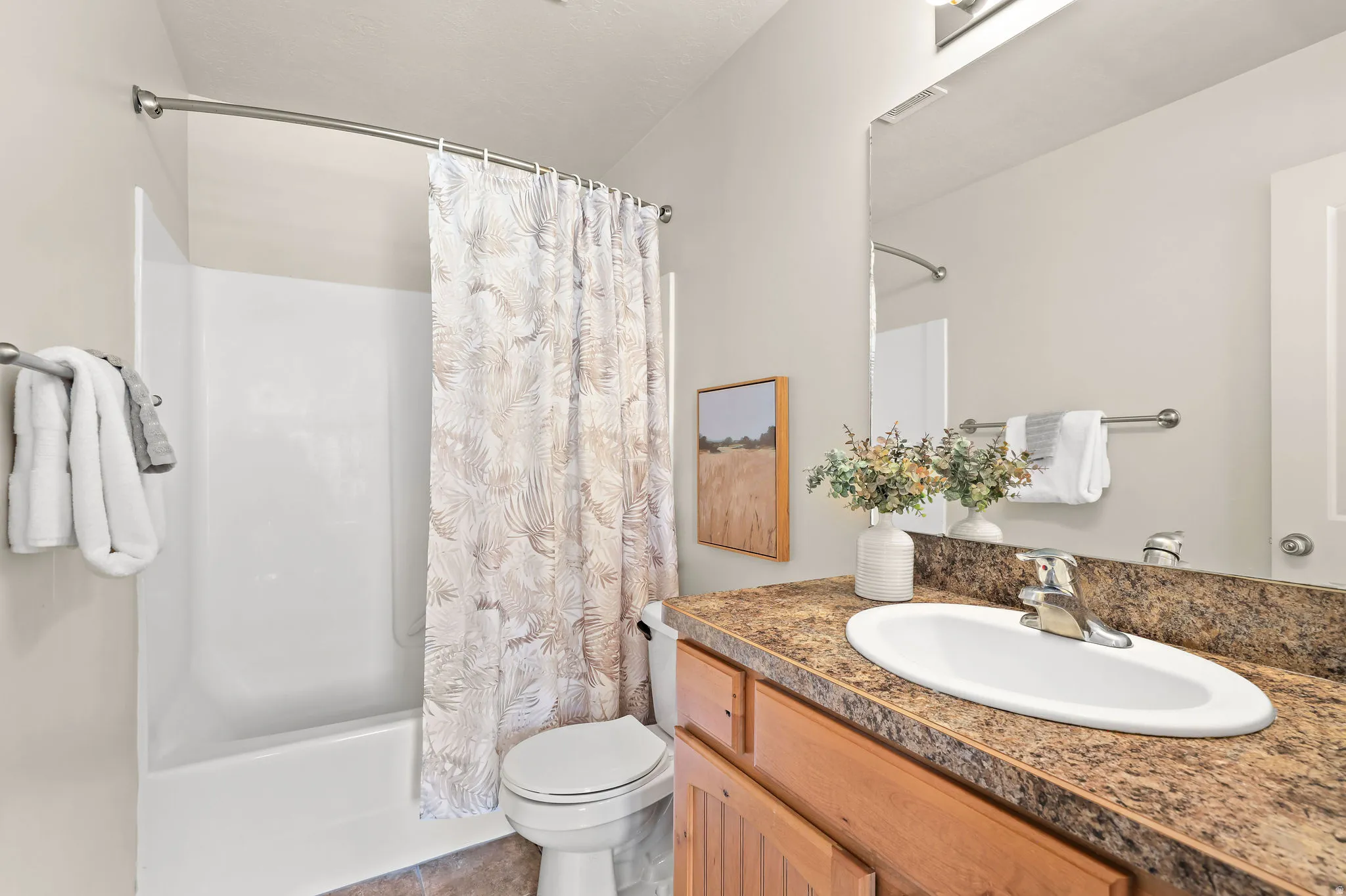 Bathroom featuring a shower-over-tub combination with a curved shower rod