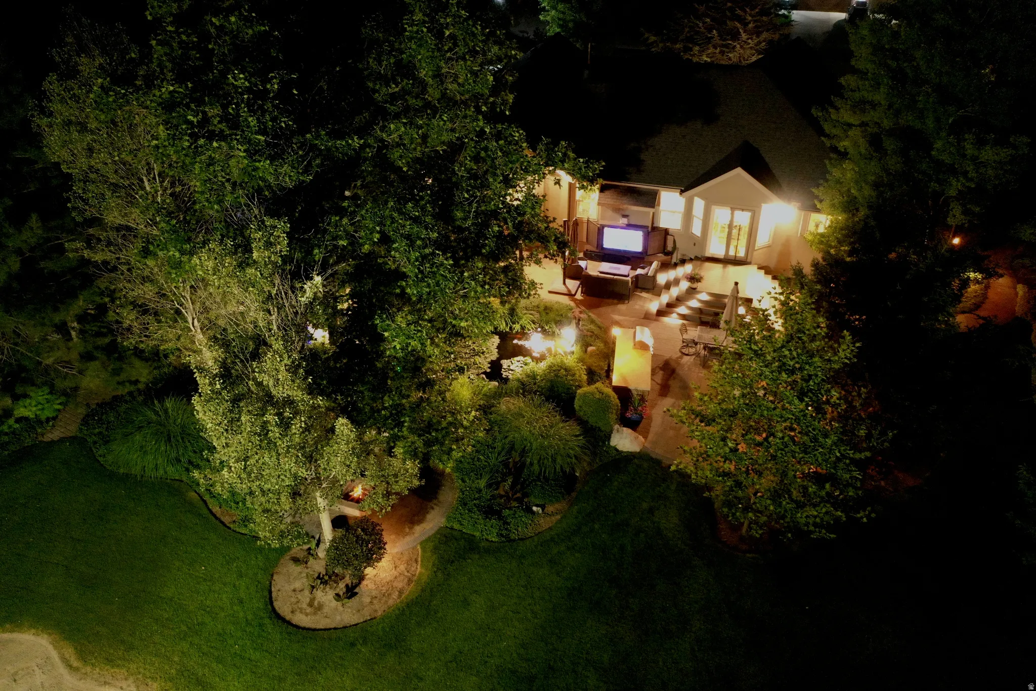Backyard patio with tiered levels and perimeter lighting