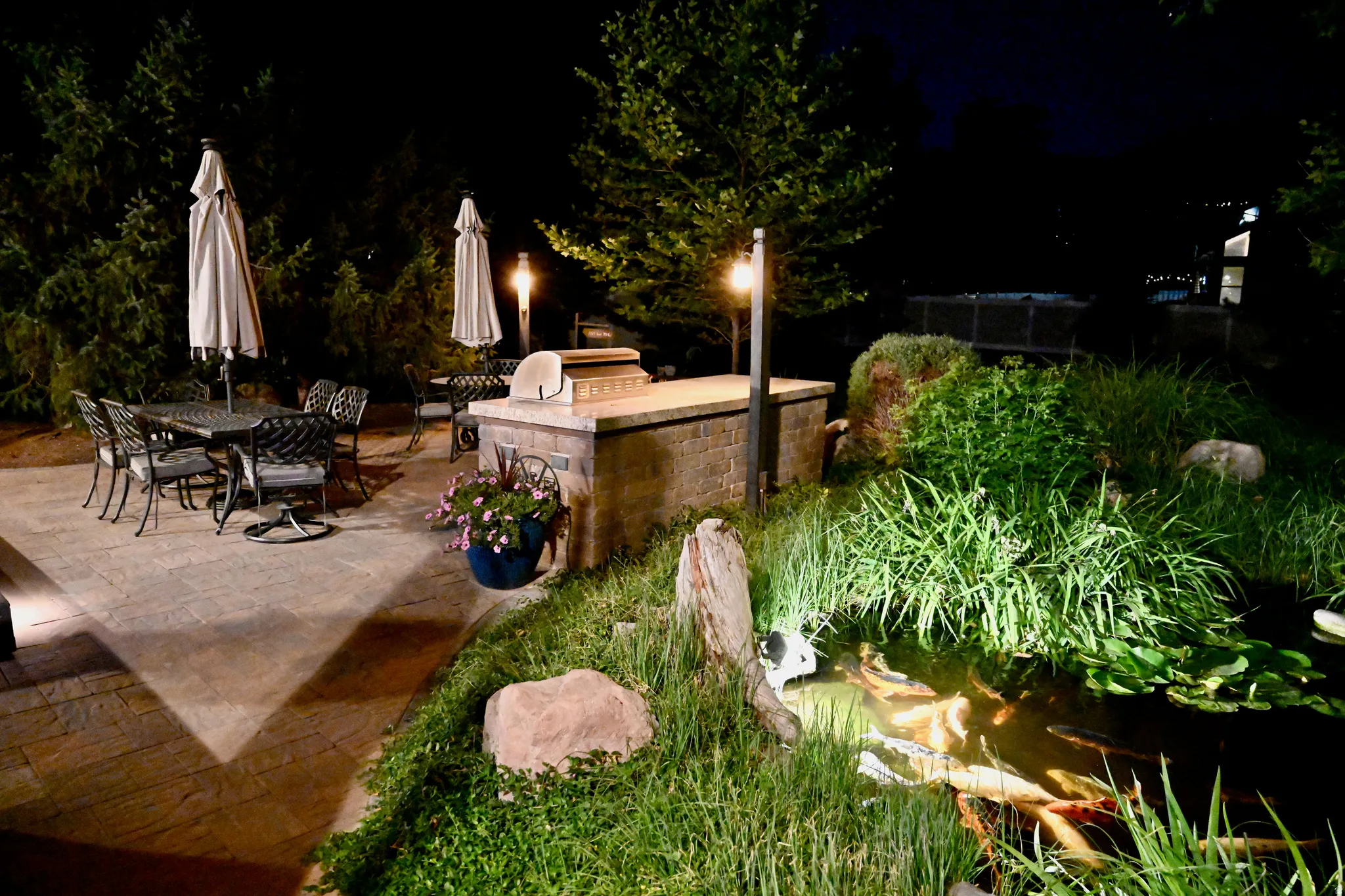 Patio with paver flooring, built-in outdoor grill station, and integrated lighting
