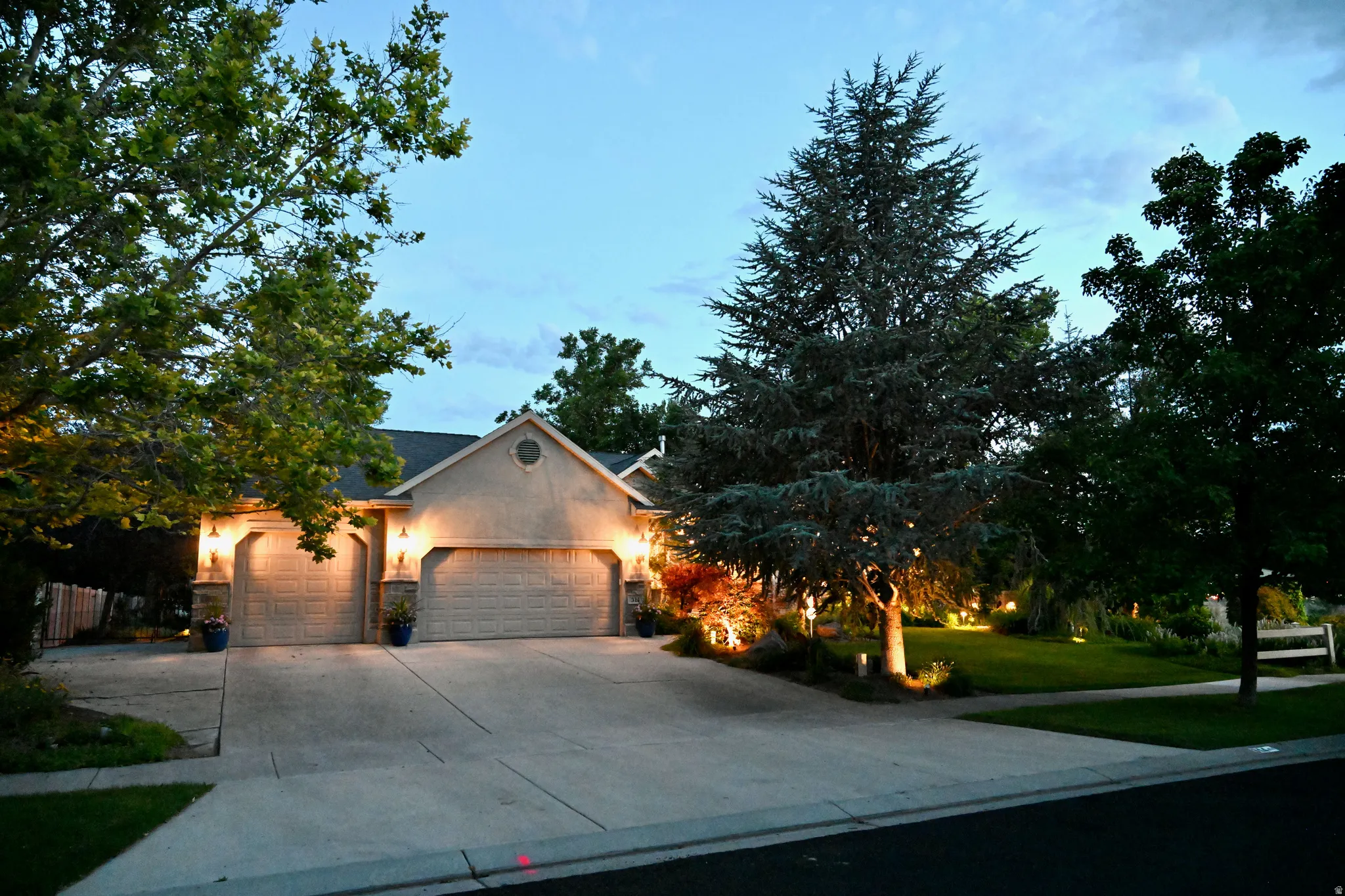 Stucco exterior residence with an attached double garage and an additional single garage