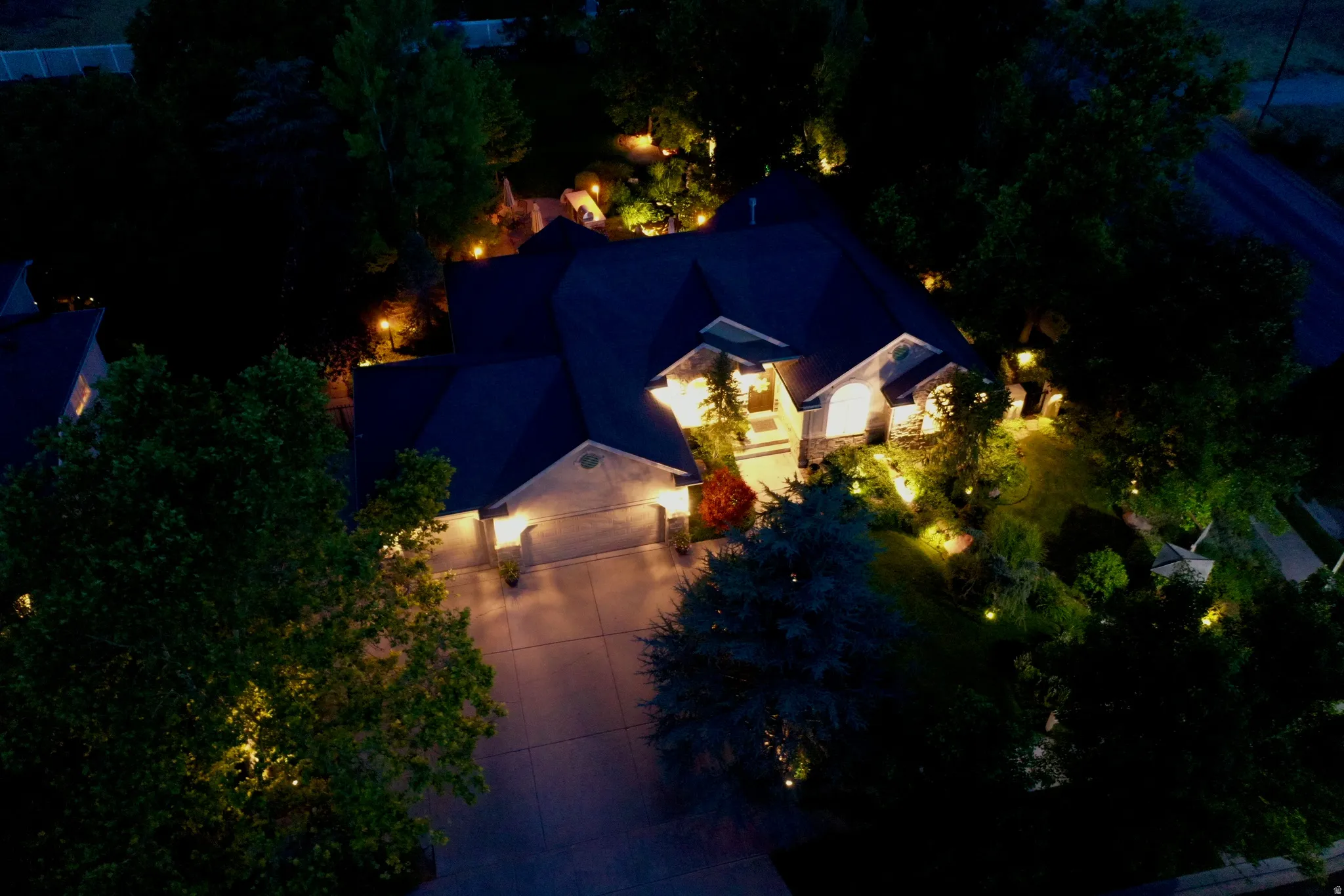 Exterior residence featuring a multi-gabled roofline and a stone facade