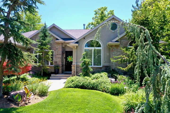 Stone and stucco exterior featuring multiple arched windows