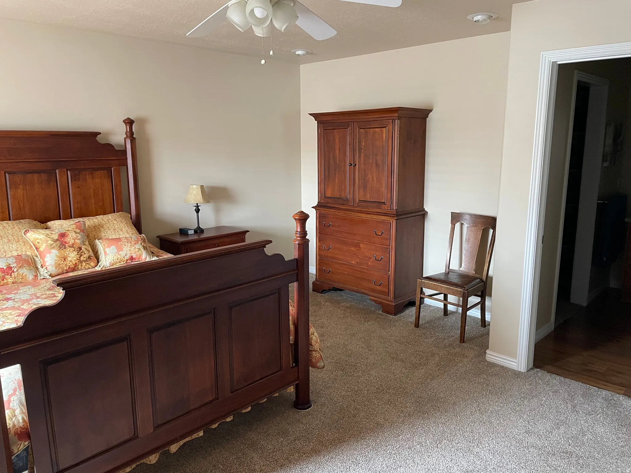Spacious room with neutral wall tones and plush carpeting