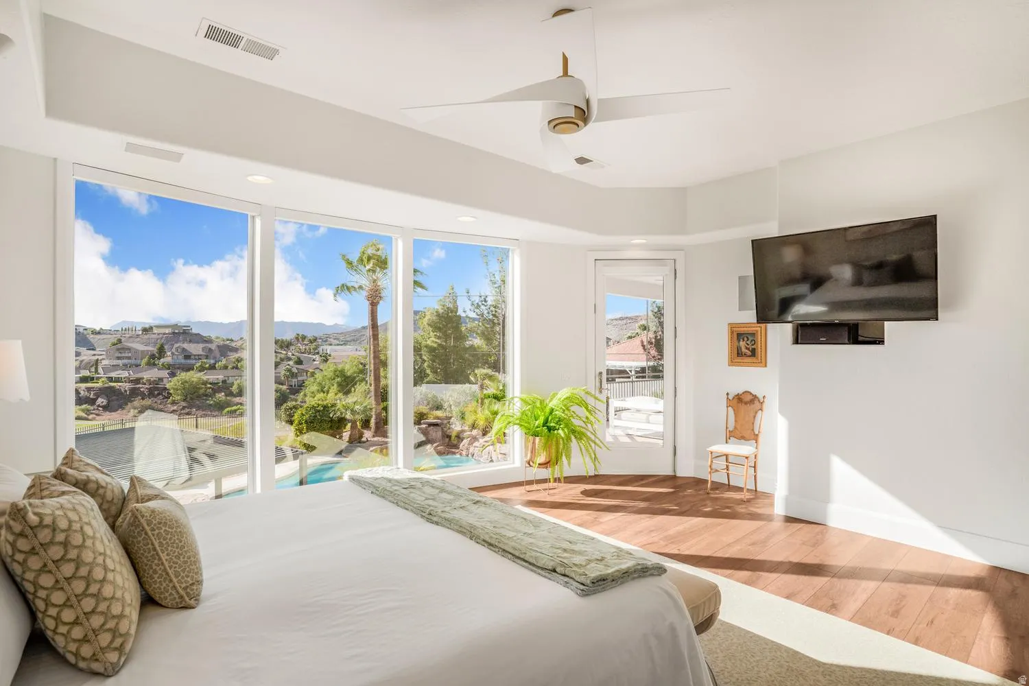 Expansive bedroom featuring large picture windows with extensive outdoor scenery