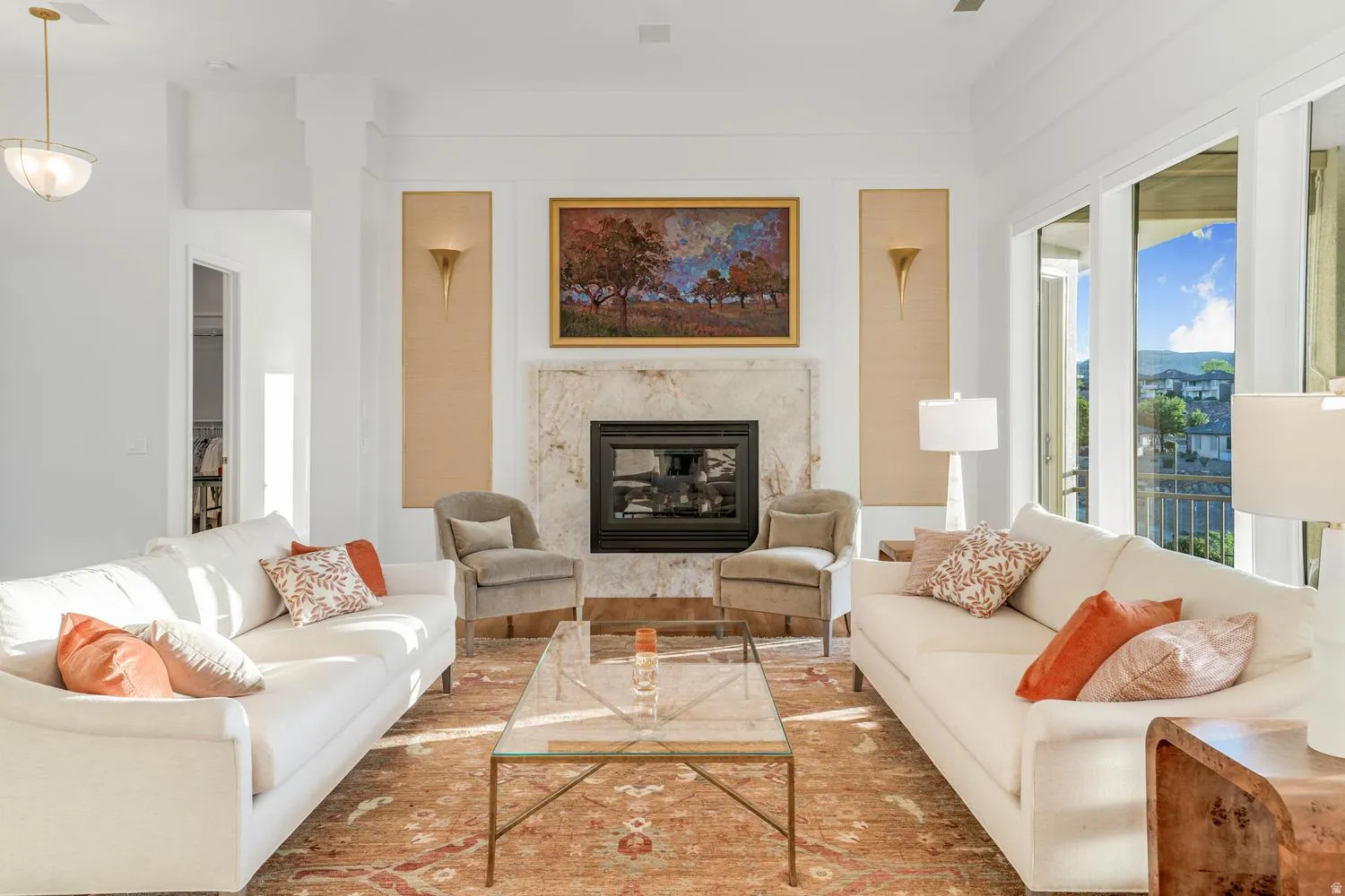Living area featuring a stone-clad fireplace with a black insert, high ceilings, large sliding glass doors, and recessed lighting