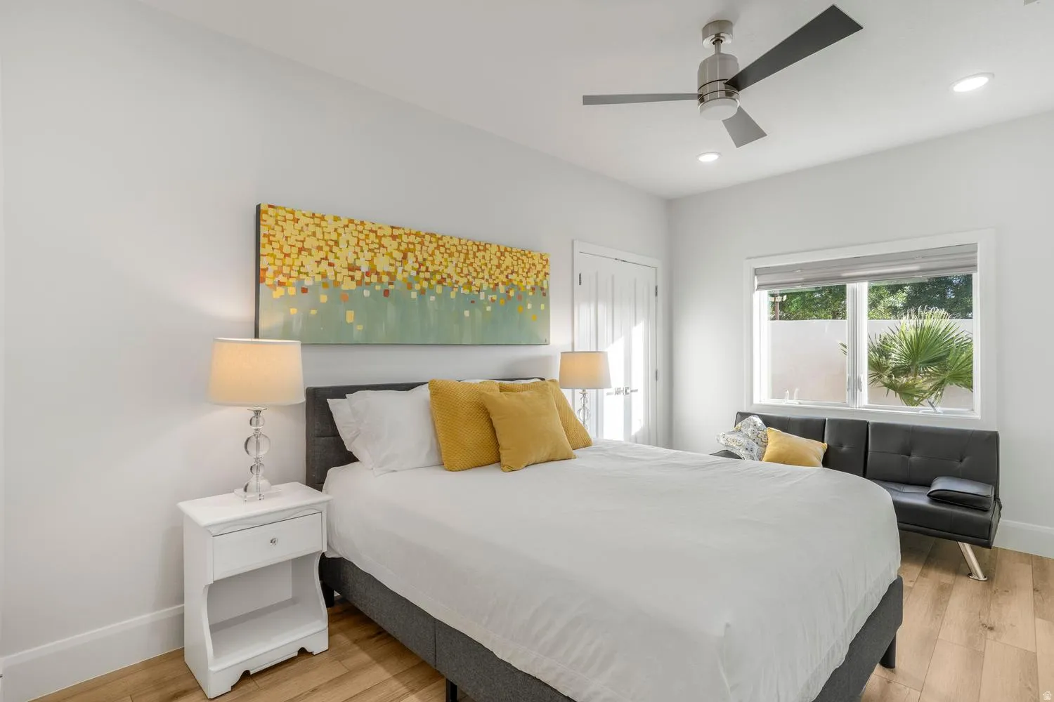 Bedroom featuring wood-finish flooring, a contemporary ceiling fan with integrated lighting, and recessed ceiling lights