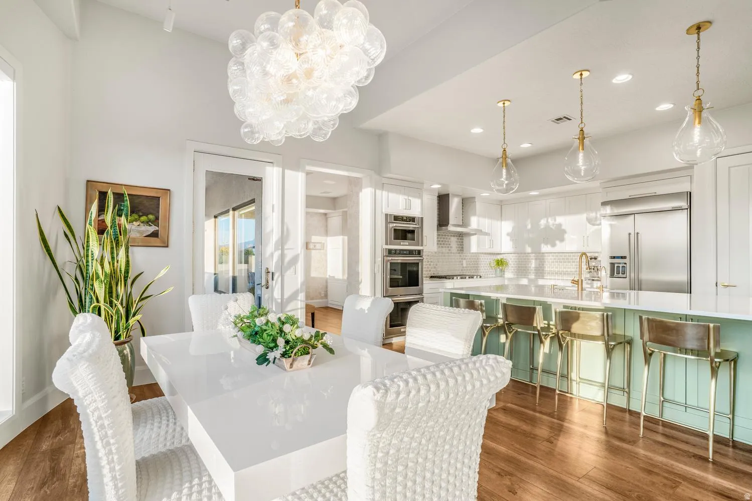 Open-concept dining and kitchen area featuring wood-finish flooring