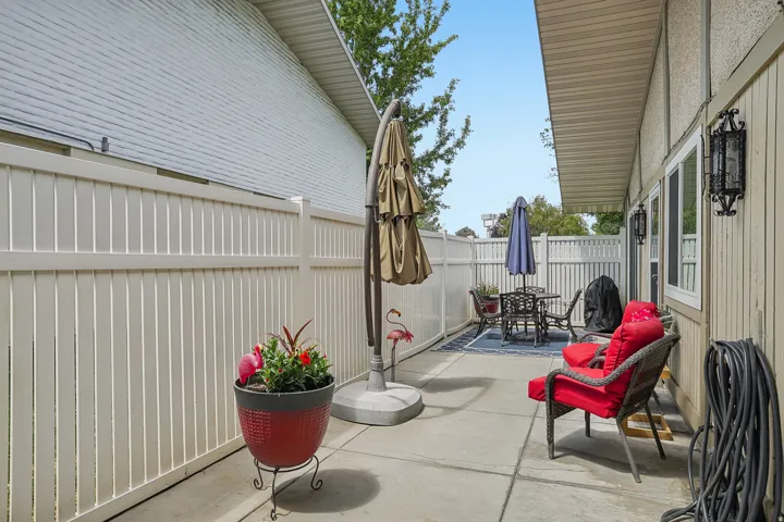 Private patio area featuring a concrete surface and perimeter fencing