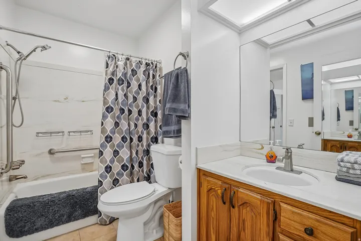 Bathroom featuring a vanity with wood-finish cabinetry and a white countertop