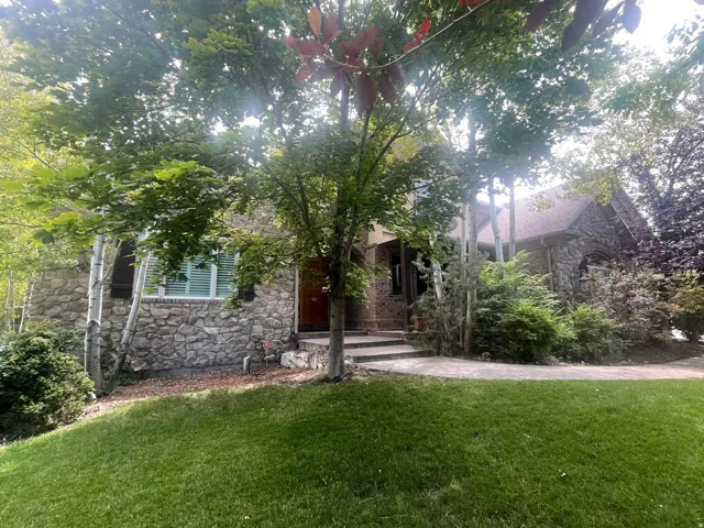 Stone facade residence with a gabled roofline