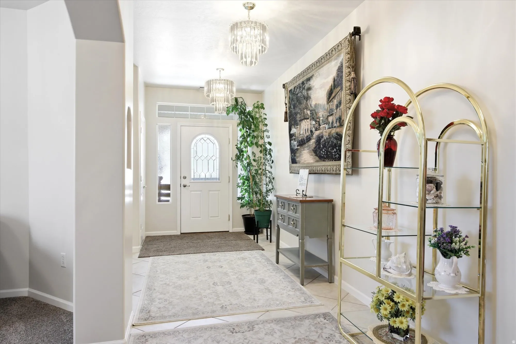 Entryway featuring a white door with decorative glass inserts and a transom window