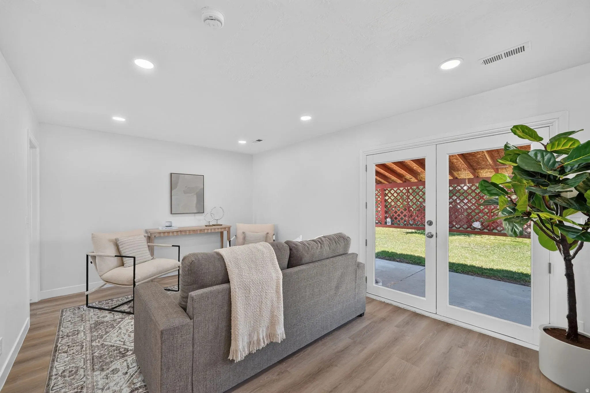 Bright interior space featuring white walls, recessed lighting, and wood-finish flooring