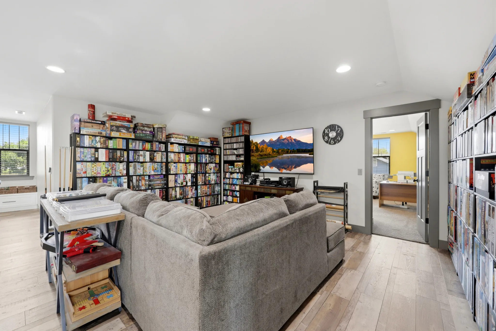 Spacious room featuring wood-finish flooring, recessed lighting, and a large window with a built-in window seat