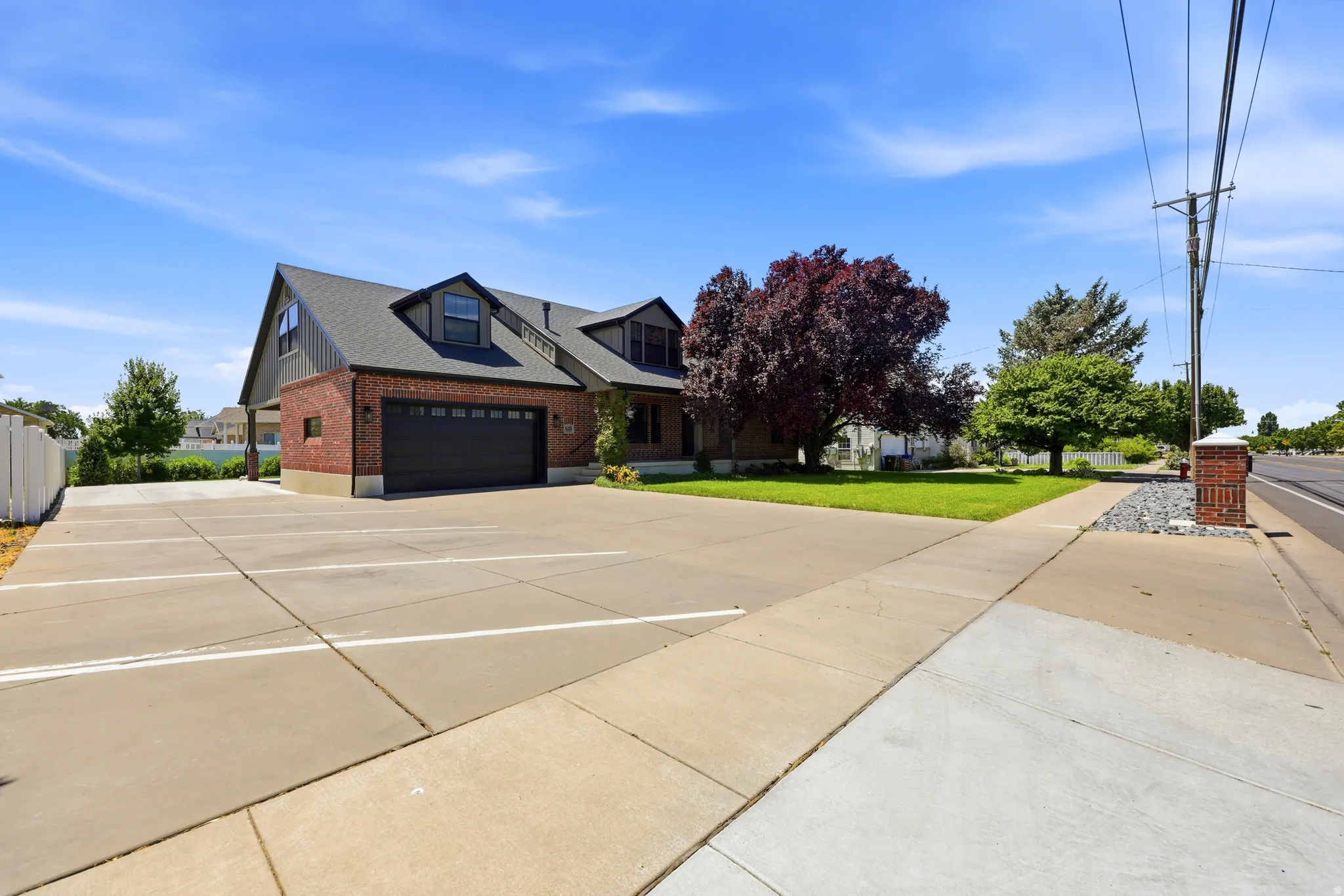 Expansive paved parking area with marked spaces and a concrete sidewalk