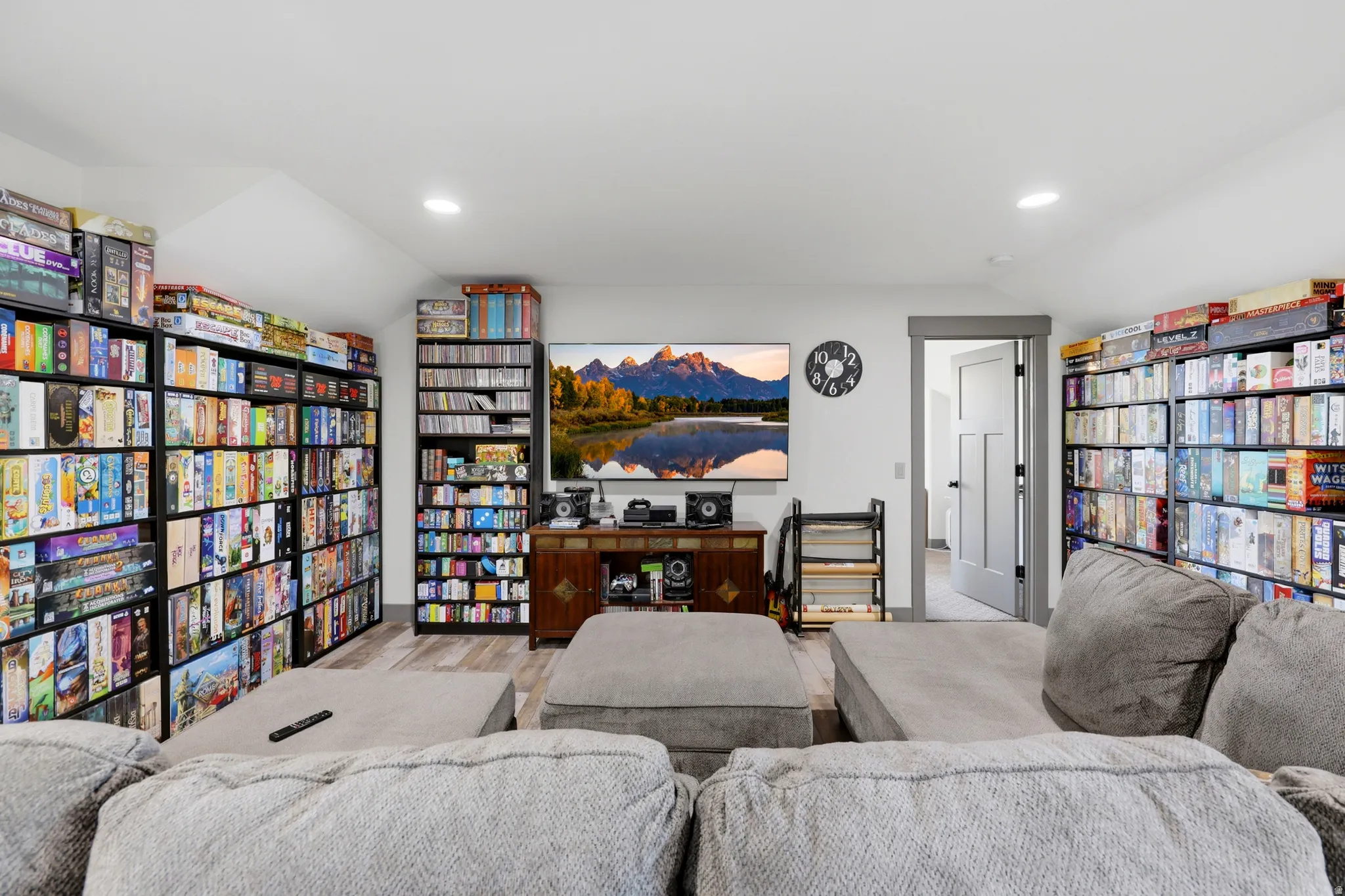 Interior space featuring light grey walls, recessed lighting, and wood-finish flooring