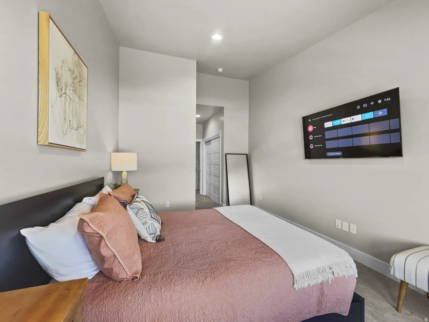 Bedroom with light gray walls, recessed lighting, and wood-finish flooring