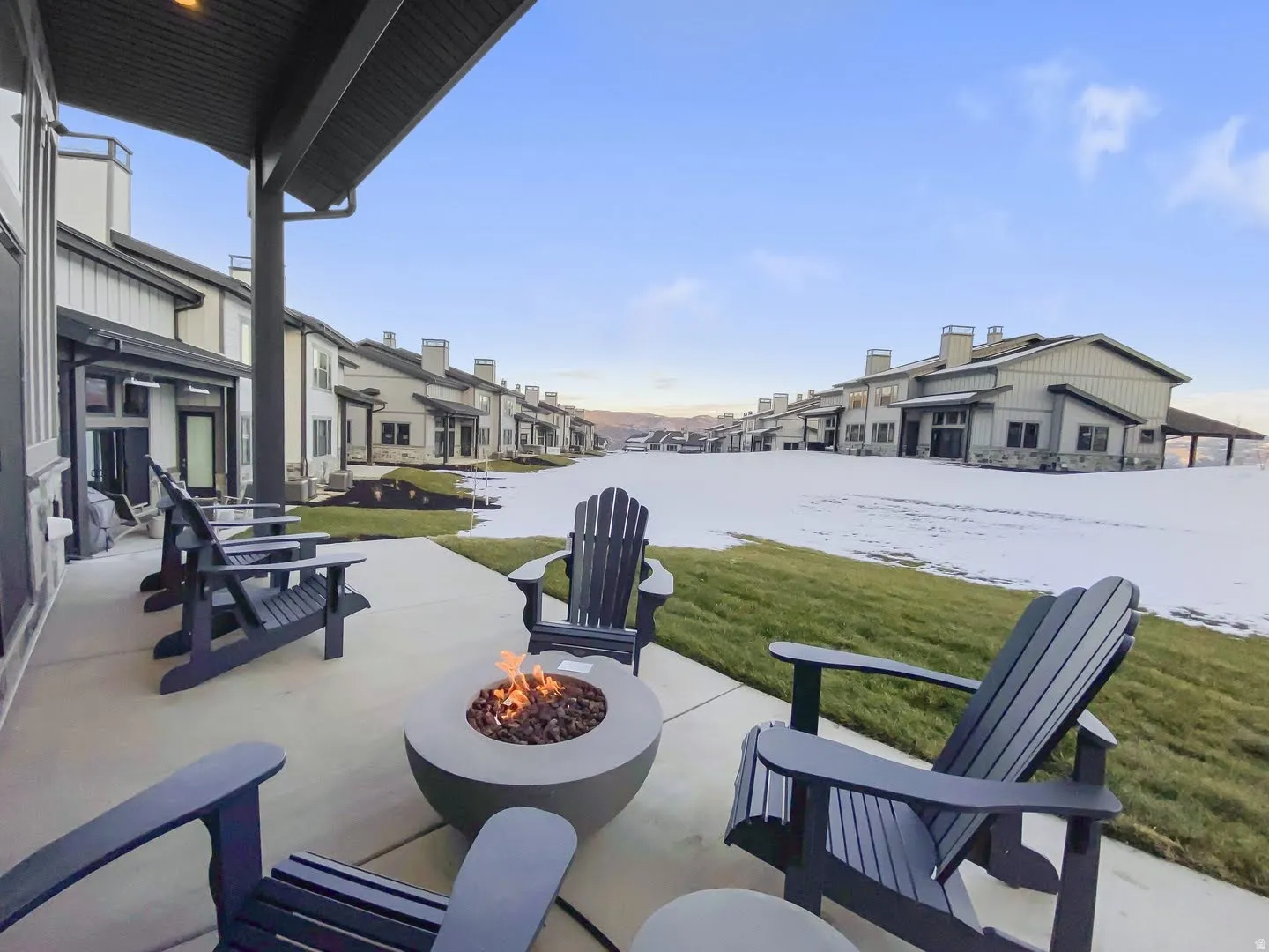 Covered patio featuring a built-in fire pit and concrete pavers