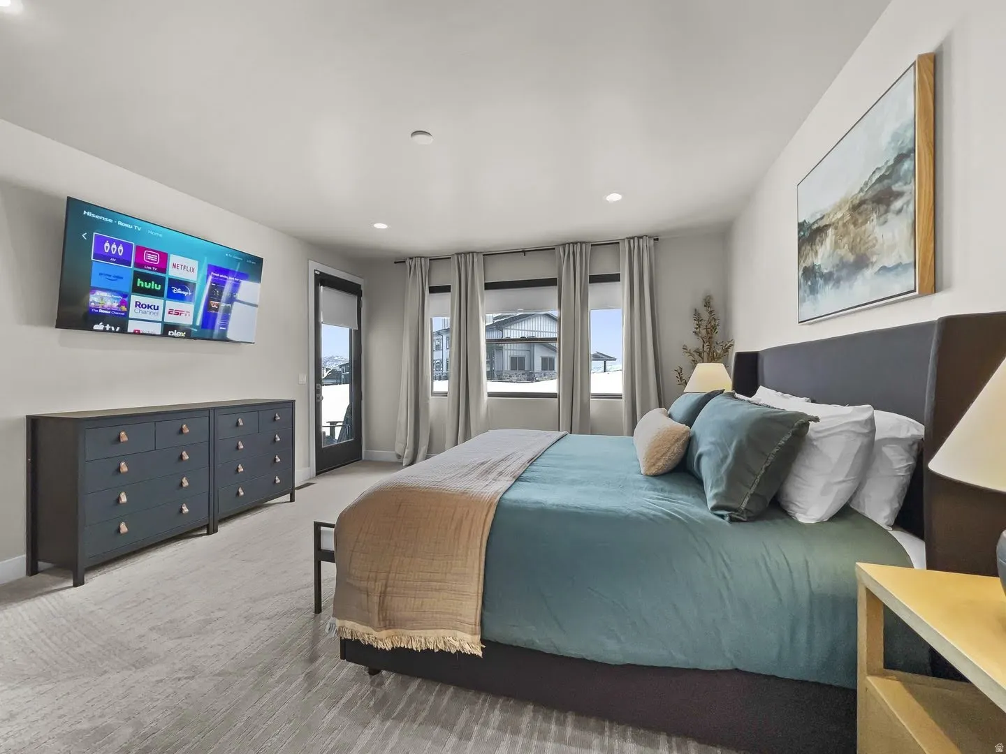 Spacious room with light-toned walls and patterned carpeting