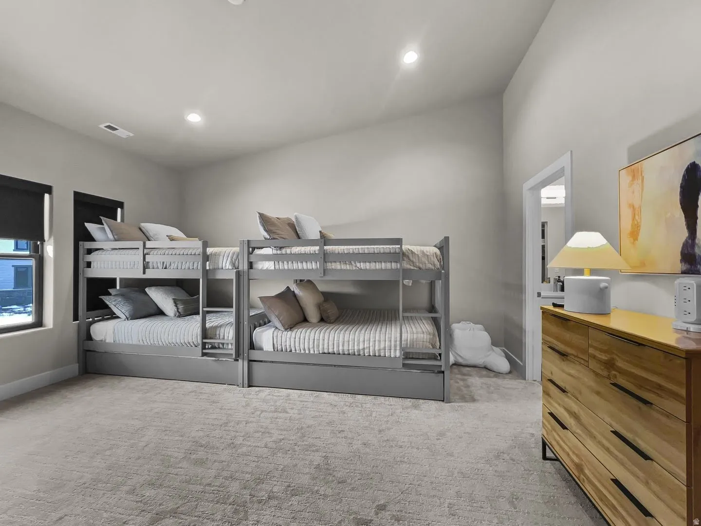 Spacious room featuring light-colored carpet flooring and recessed ceiling lighting