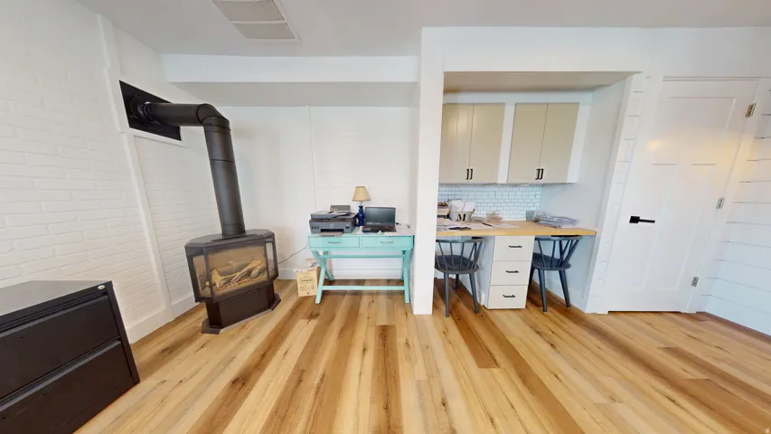 Wood-finish flooring throughout, complemented by white painted brick walls
