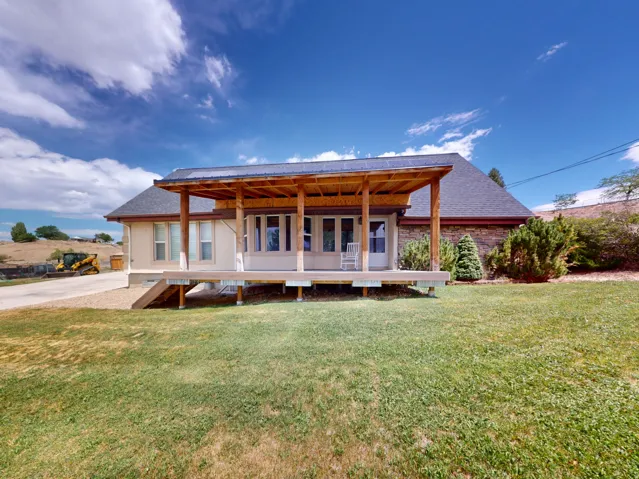 Ranch-style exterior with a covered wooden deck