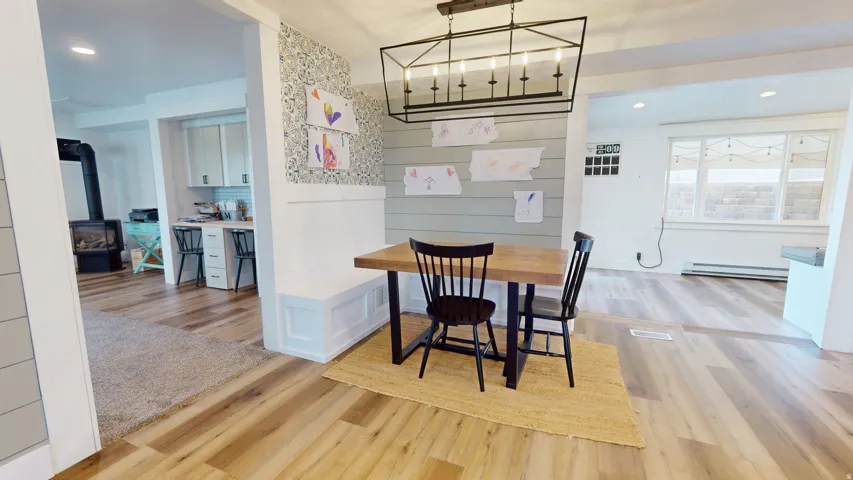 Dining area with built-in bench seating and a contemporary linear chandelier