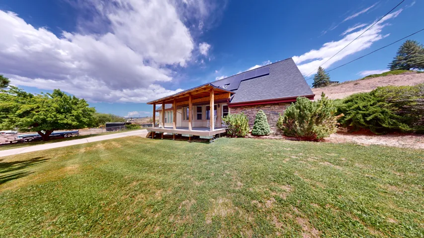 Stone-clad exterior featuring a covered porch with natural wood pillars and railings