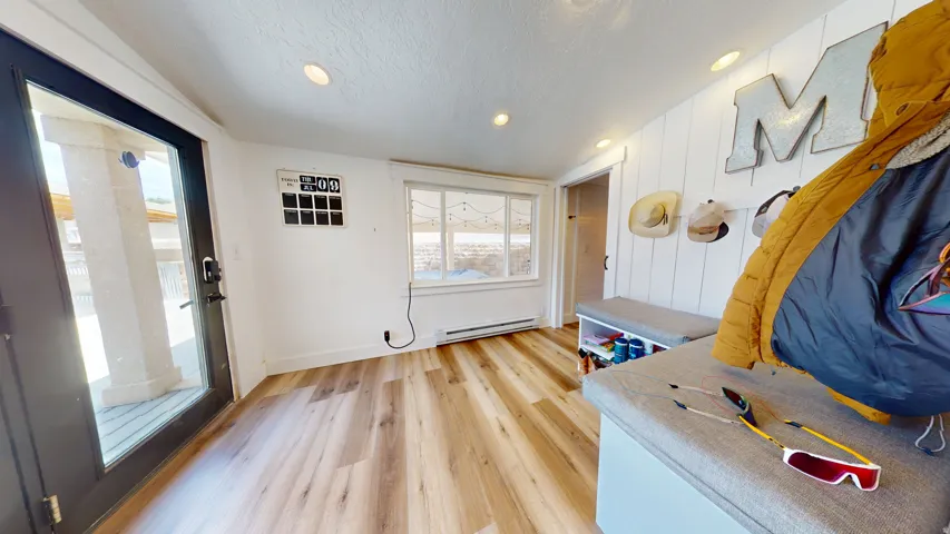 Entryway featuring wood-finish flooring, recessed lighting, and a full-light exterior door