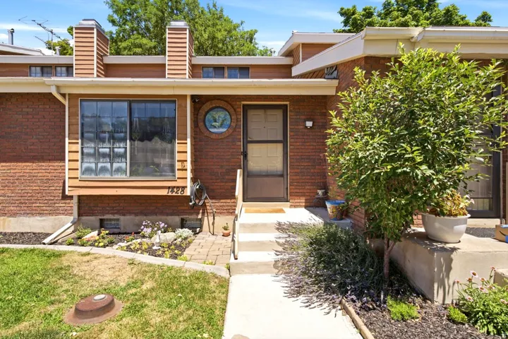 Brick exterior featuring a wood-clad bay window with glass block accents