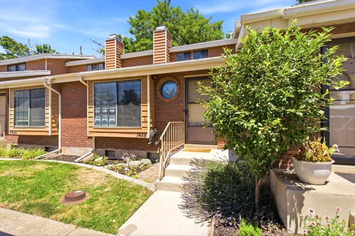Brick and wood-sided exterior featuring multiple windows and a distinct round architectural window