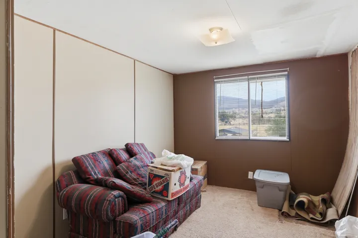 Room featuring a window with integrated blinds and a mountain backdrop