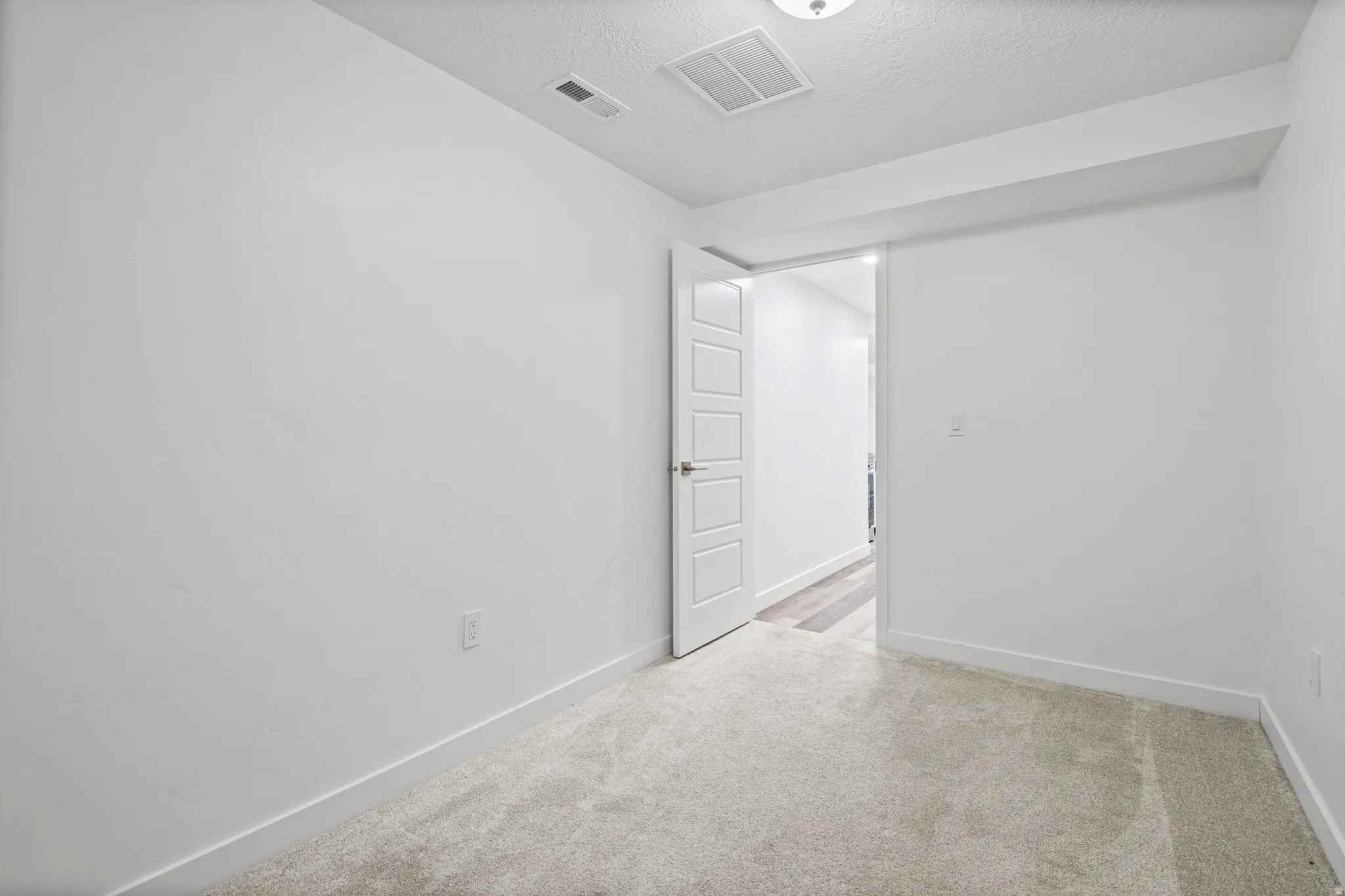 Neutral-toned carpeting paired with white walls