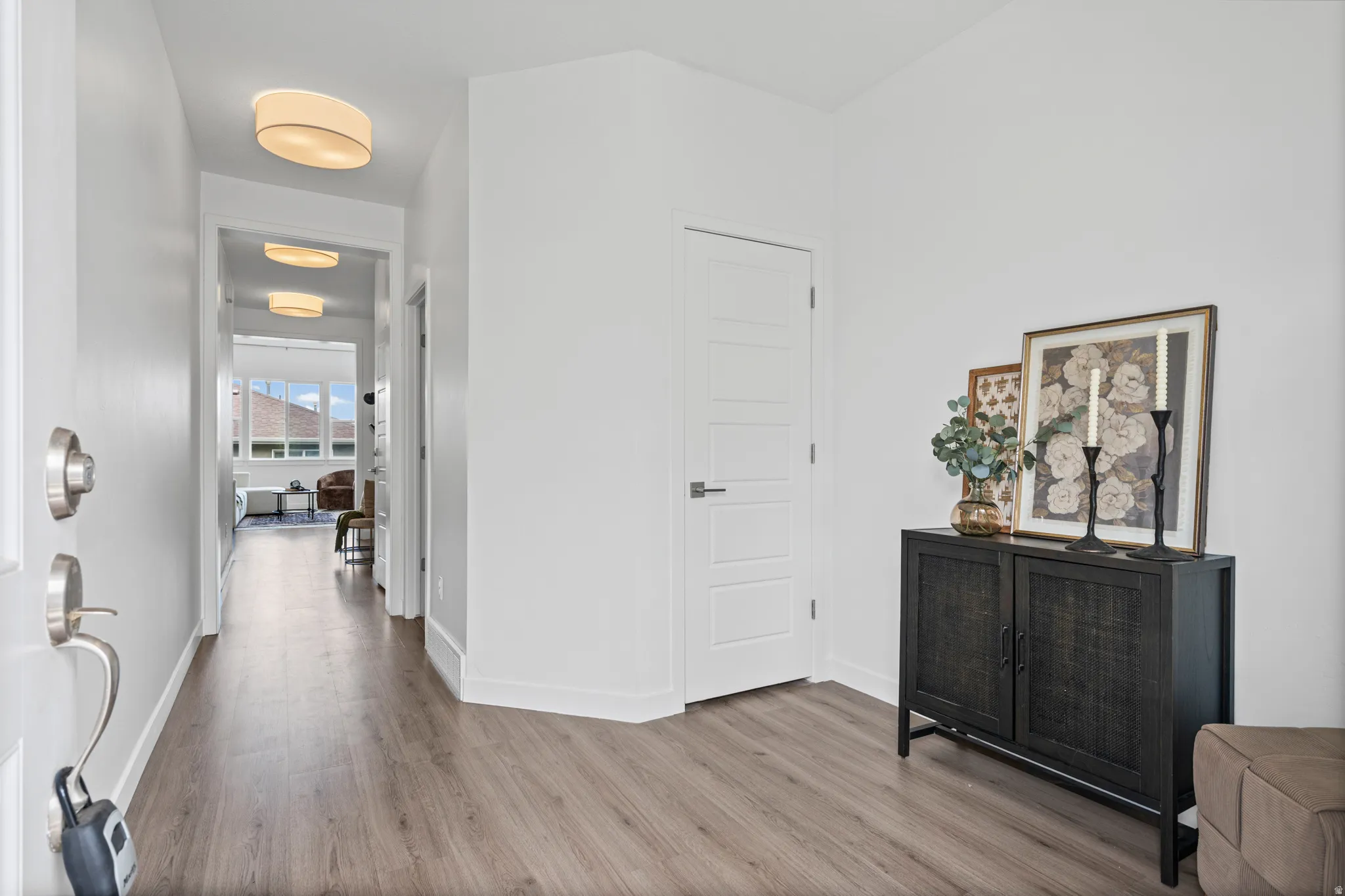 Entryway featuring wood-finish flooring and white baseboards