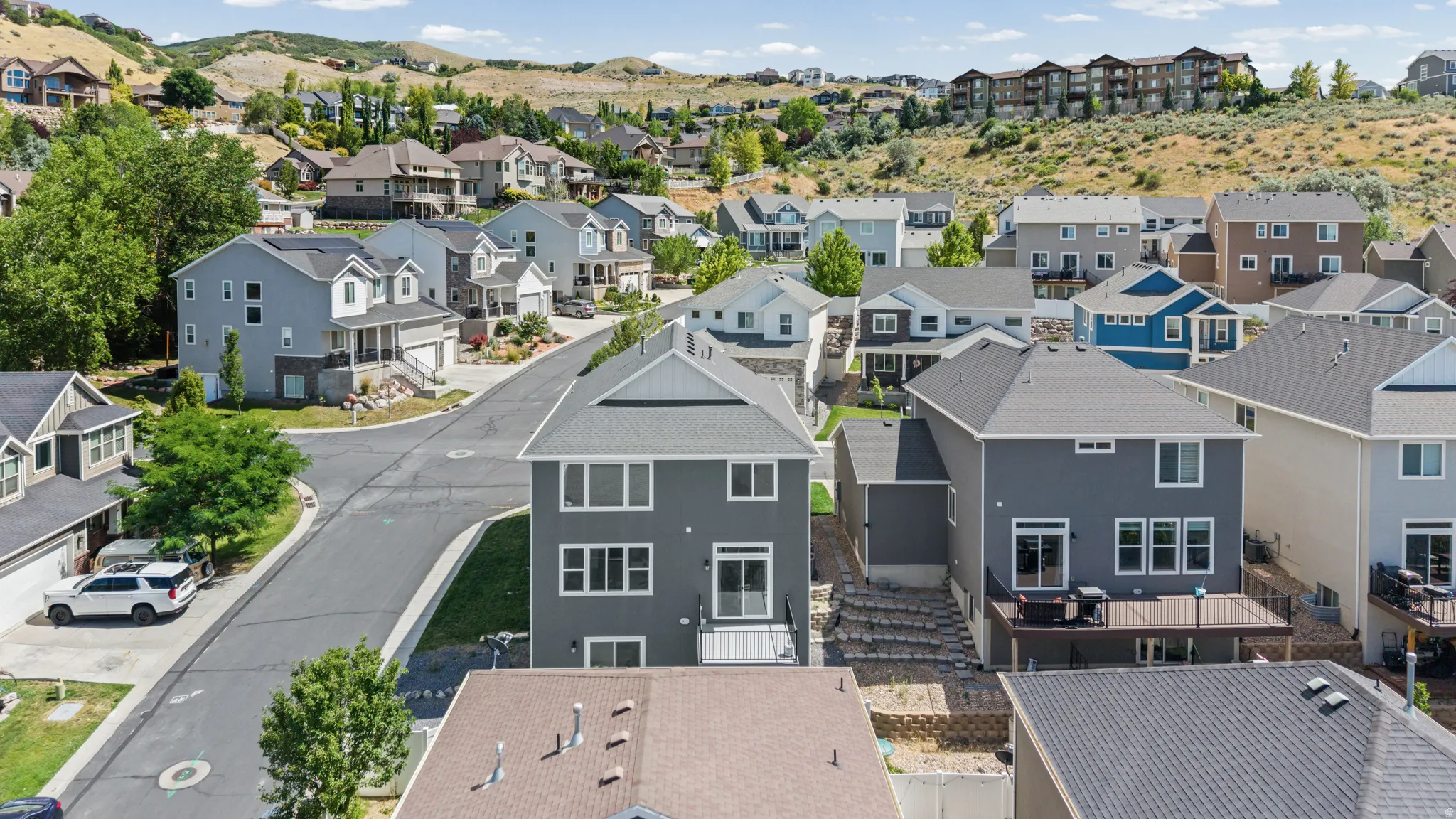 Hillside residential community featuring varied architectural styles and mature landscaping