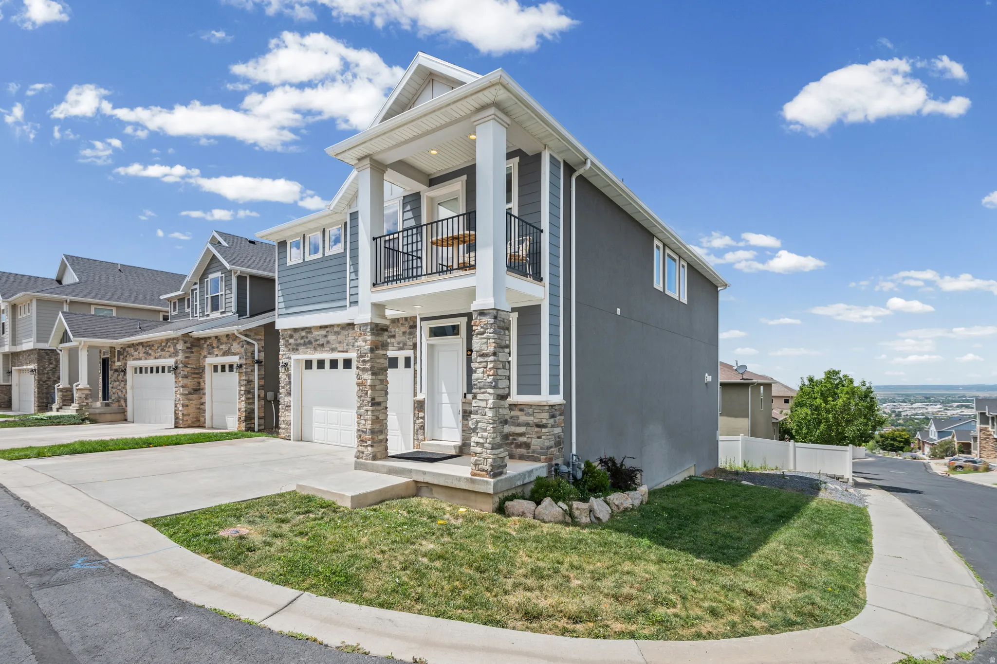 Contemporary two-story residence featuring a stone and siding exterior