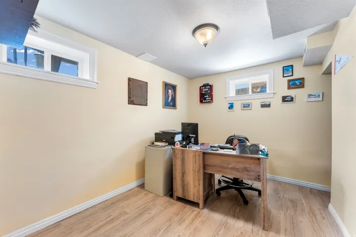 Versatile room featuring wood-finish flooring, light-toned walls, and recessed lighting