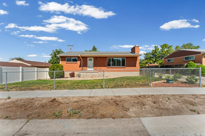 Single-story brick exterior with a gray shingle roof