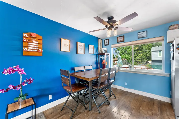 Dining area featuring wood-finish flooring and a ceiling fan with integrated lighting