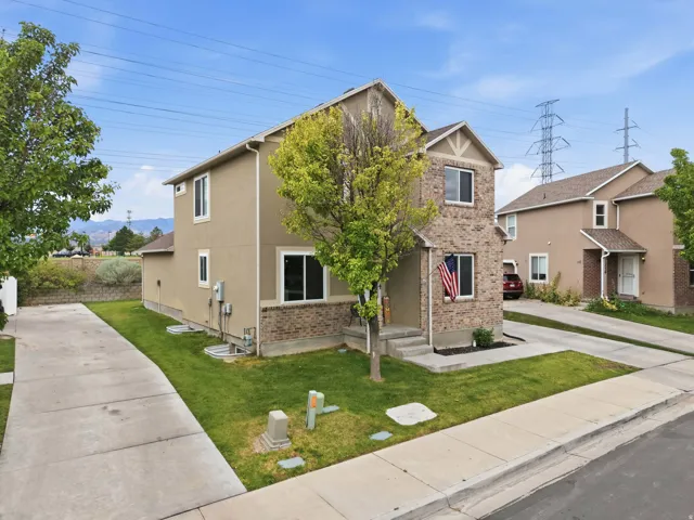 Two-story residence featuring a brick and stucco exterior