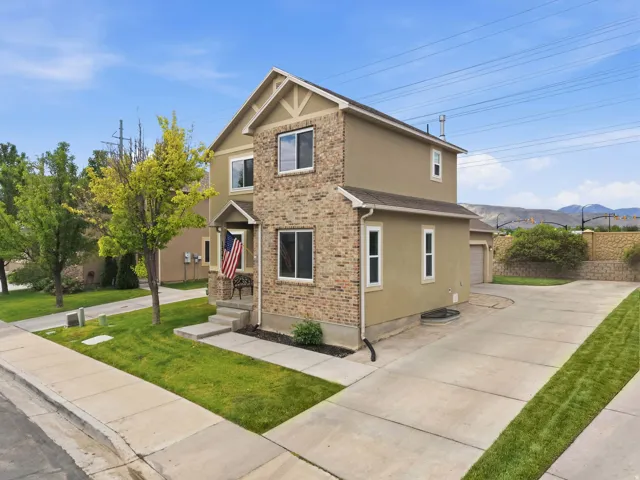 Two-story property featuring a brick and stucco exterior
