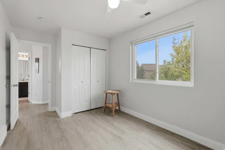 Bright room featuring light wood-finish flooring and a large window