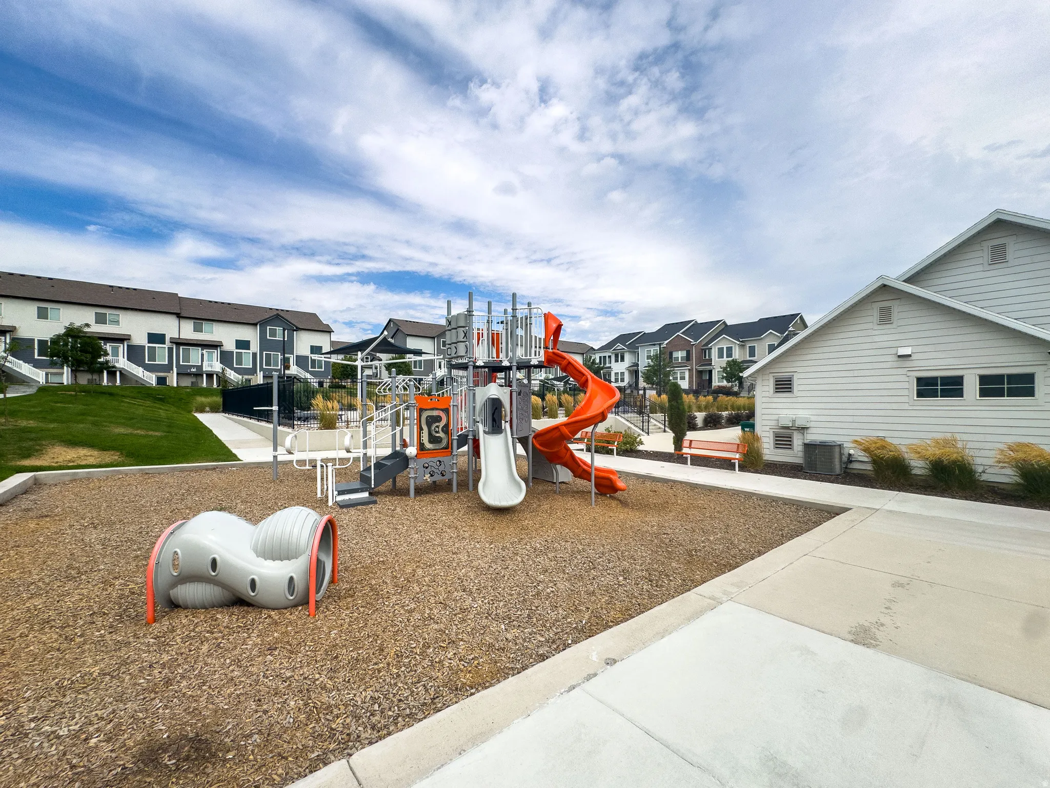 Community playground featuring multiple slides and climbing structures