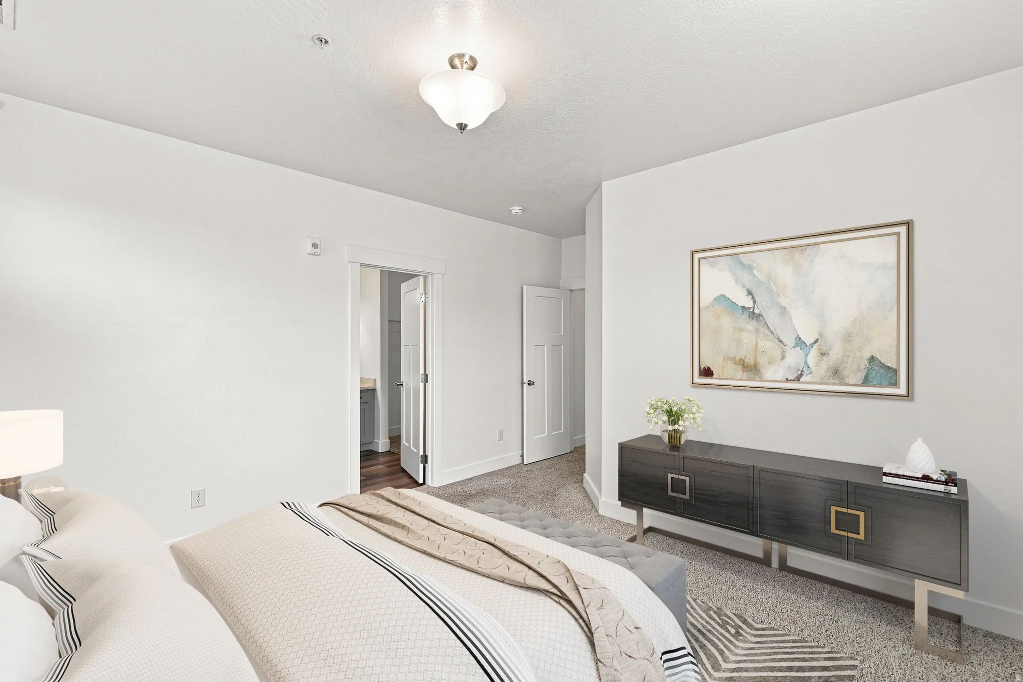 Spacious room featuring neutral carpeting, light-toned walls, and a ceiling-mounted light fixture