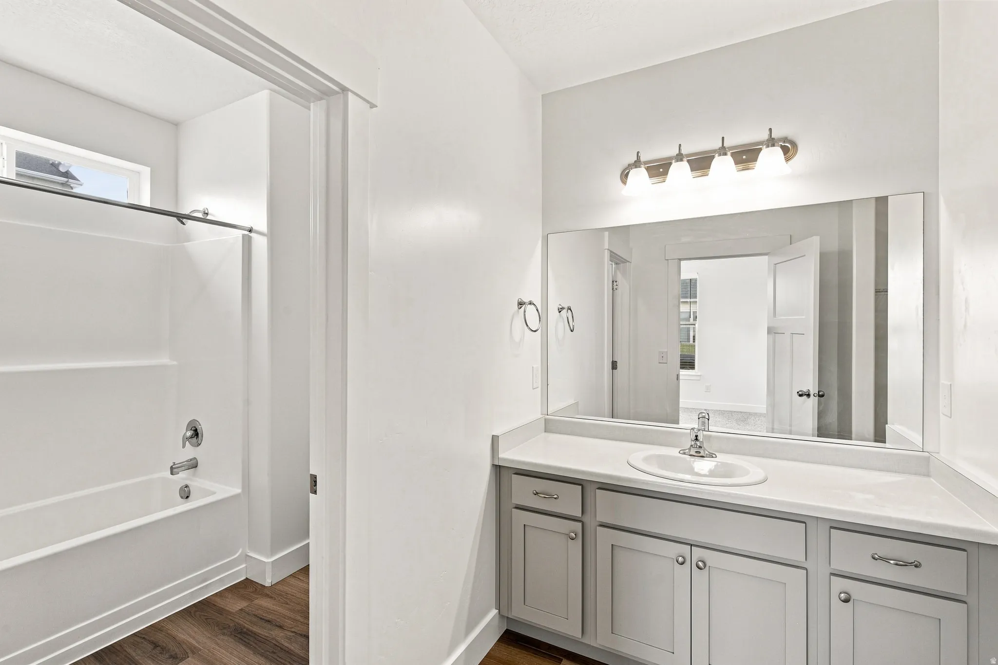 Bathroom featuring a single vanity with light cabinetry and a white countertop
