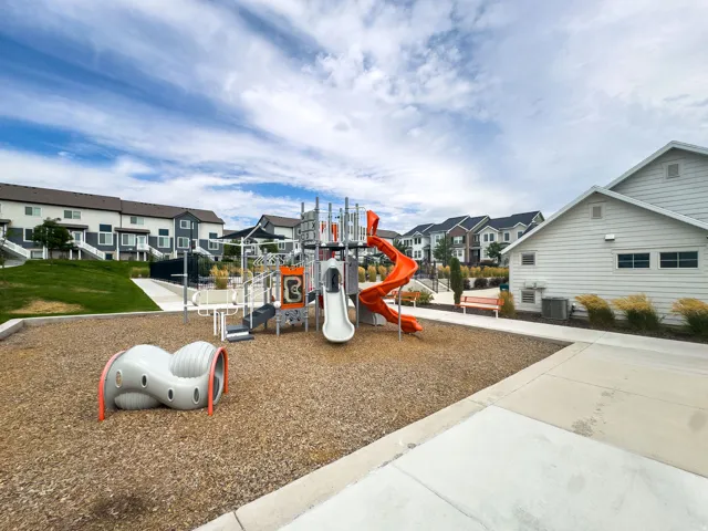 Community playground featuring multiple slides and climbing structures
