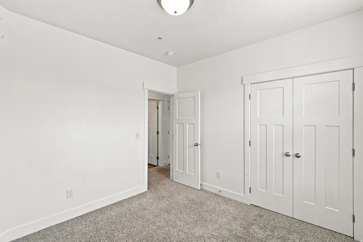 Interior room featuring light gray carpet, white walls, and white trim