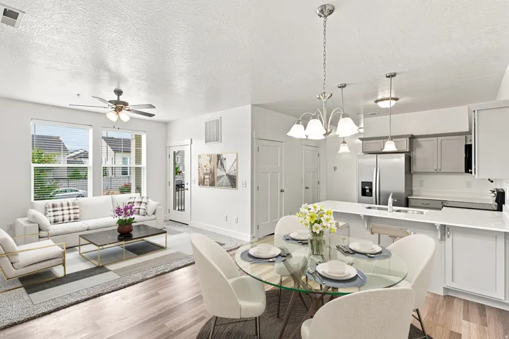 Open concept living area featuring wood-finish flooring, a ceiling fan, and large windows with blinds