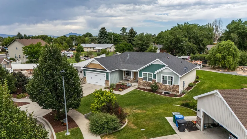 Contemporary exterior with a two-car garage, stone veneer accents, and a covered porch