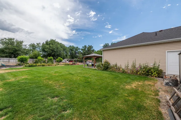 Expansive green lawn with a wood fence perimeter