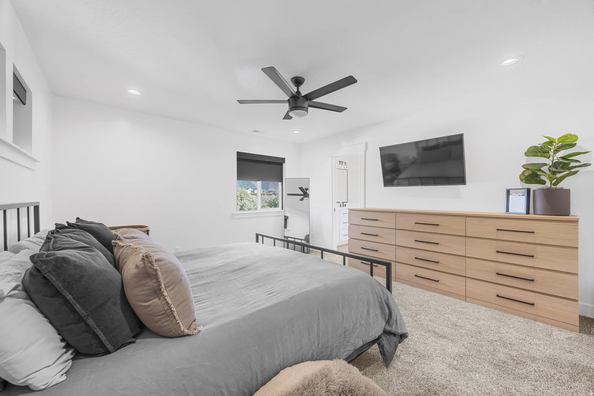 Neutral color palette bedroom featuring recessed lighting, a modern ceiling fan, and carpet flooring
